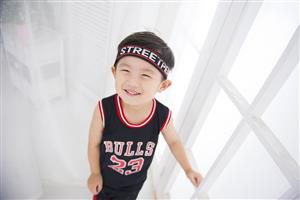 Smiling Boy Wearing A Chicago Bulls Uniform #23