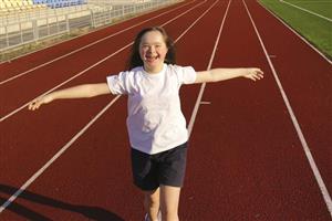 Happy girl running race track